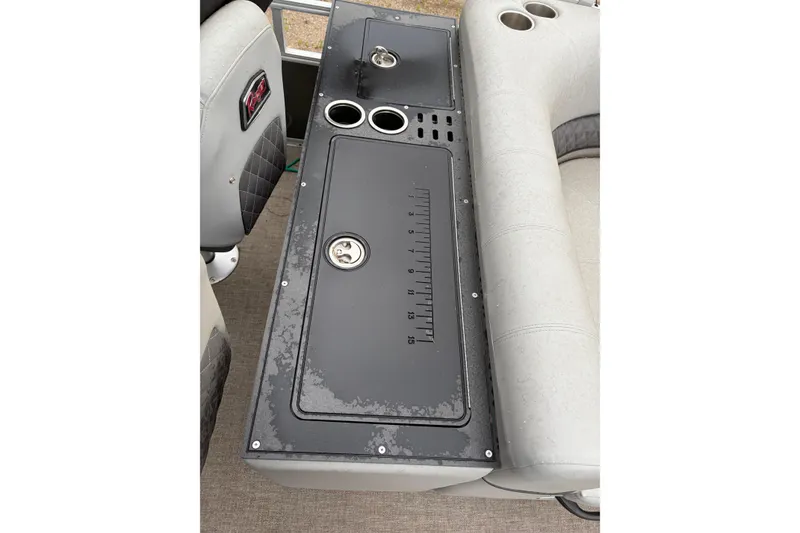 Slide: The Image of 2023 Ranger 220FC boat console with cup holders and measuring scale. - 10