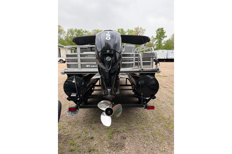 Slide: The Image of Rear view of a 2023 Ranger 220FC boat with a powerful outboard motor. - 13