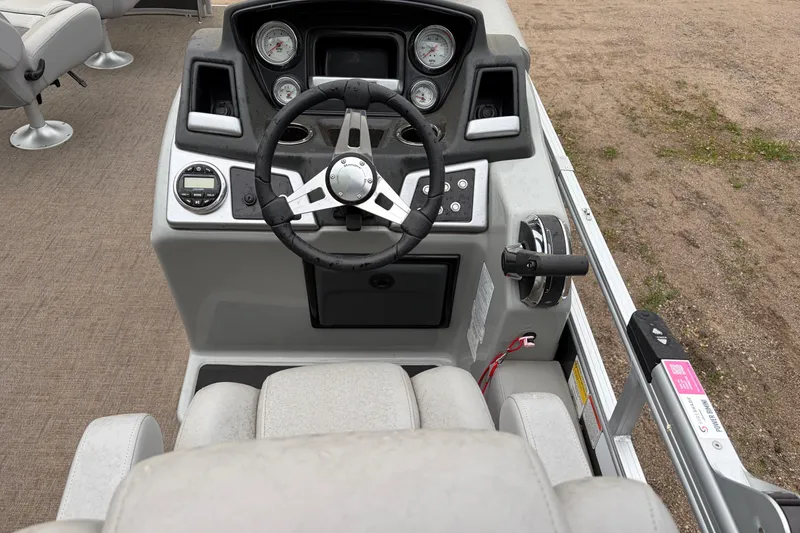 Slide: The Image of 2023 Ranger 220FC boat dashboard with steering wheel and control panel. - 7