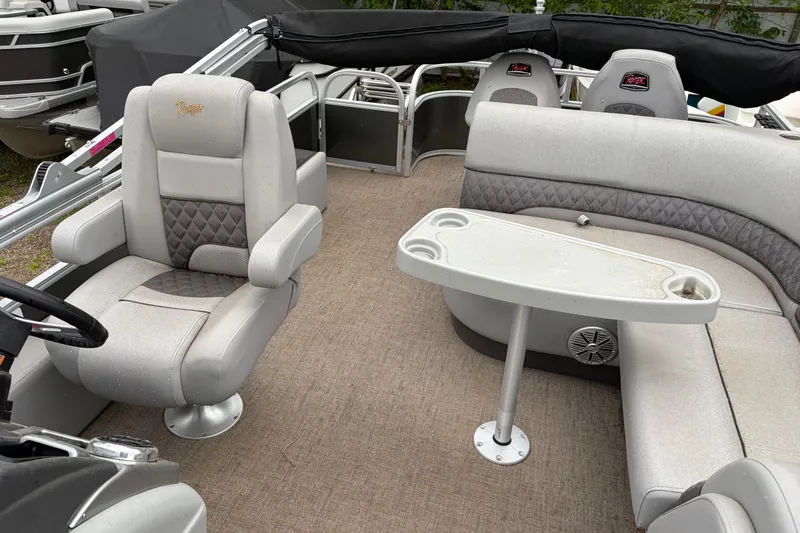 Slide: The Image of Interior of 2023 Ranger 220FC boat with seating and table setup. - 9