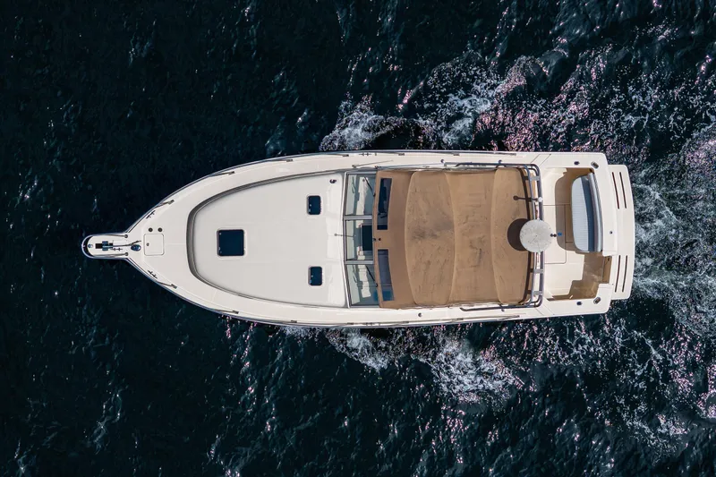 Slide: The Image of Aerial view of 2004 Mainship Pilot 34 cruising on open water. - 11