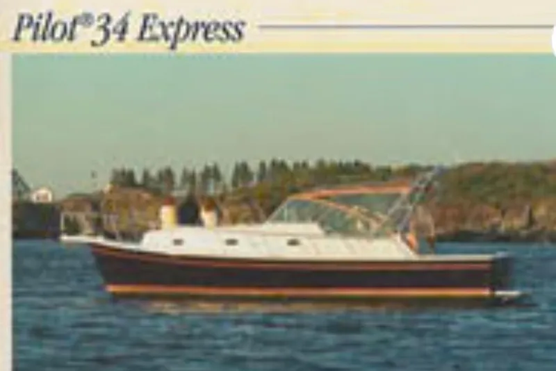 Slide: The Image of 2004 Mainship Pilot 34 boat cruising on a calm lake with scenic background. - 14