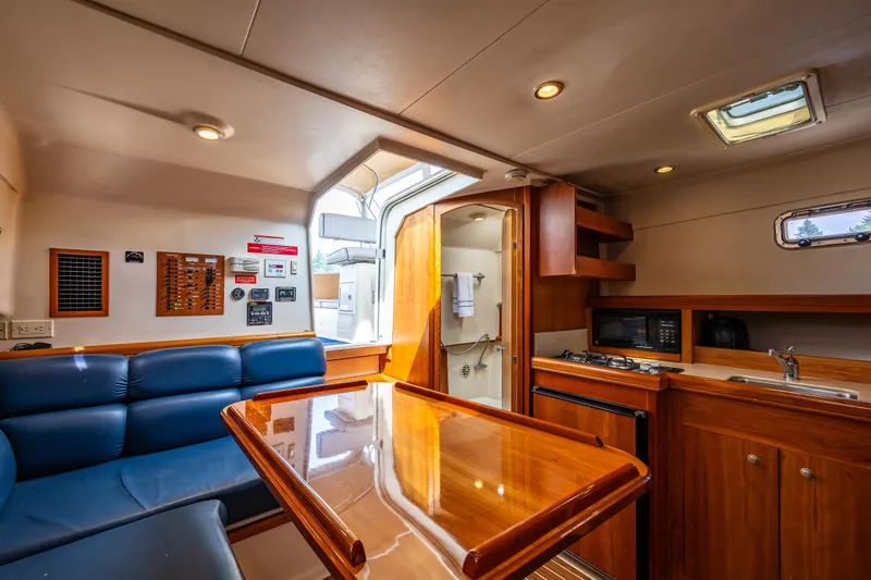 Slide: The Image of Interior of 2004 Mainship Pilot 34 yacht with the Galley and Salon area. - 27