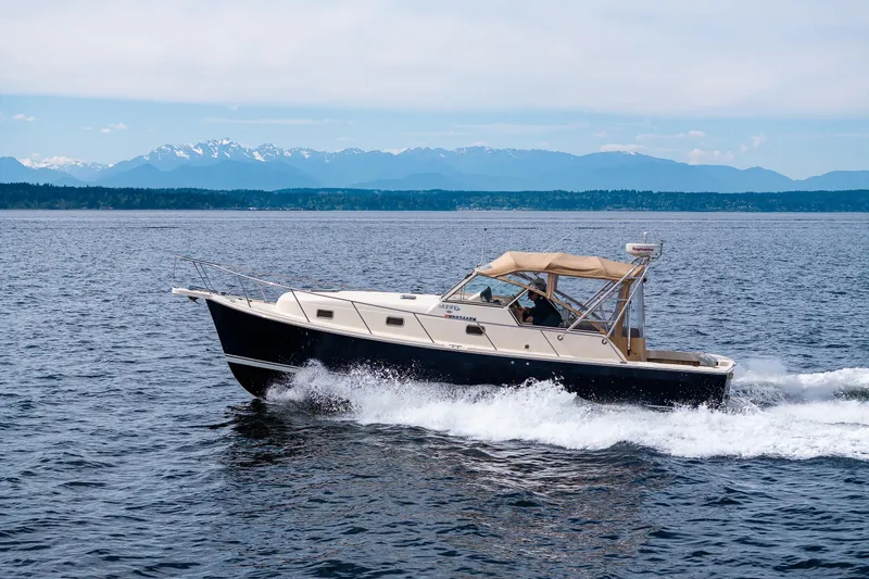 Slide: The Image of 2004 Mainship Pilot 34 cruising on the Puget Sound with the Olympics Mountains in the background. - 3