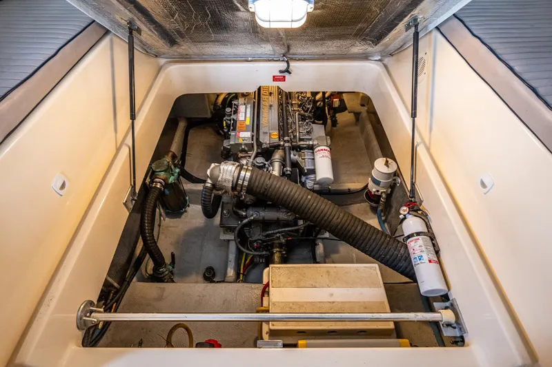 Slide: The Image of Engine compartment of a 2004 Mainship Pilot 34, showcasing mechanical components and systems. - 33