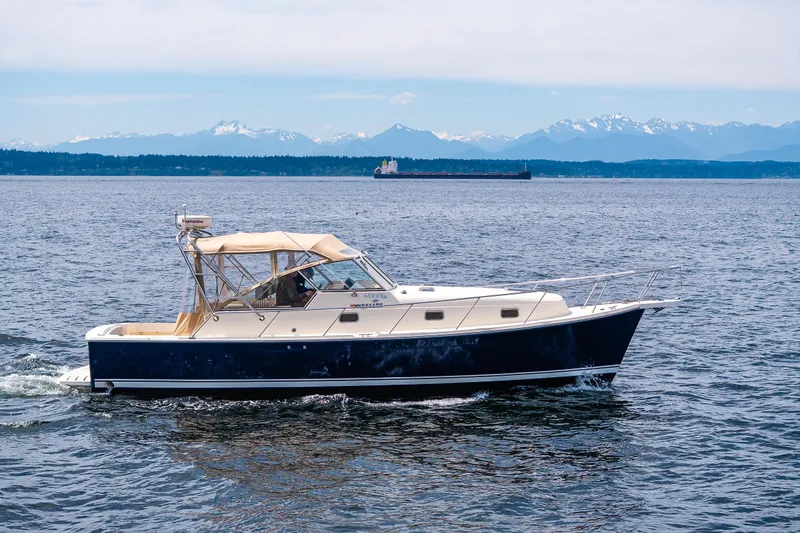 Slide: The Image of 2004 Mainship Pilot 34 cruising on the Puget Sound with the Olympics Mountains in the background. - 4