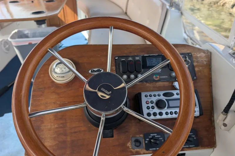 Slide: The Image of Steering wheel and controls of a 2007 Duffy Cuddy Cabin 22 boat. - 17