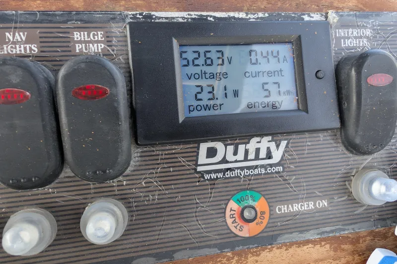 Slide: The Image of Control panel of a 2007 Duffy Cuddy Cabin 22 boat displaying voltage, current, and power. - 18