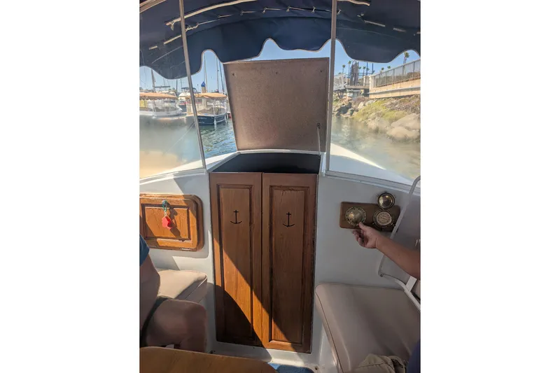 Slide: The Image of Interior view of a 2007 Duffy Cuddy Cabin 22 boat with wooden cabinetry and nautical instruments. - 23