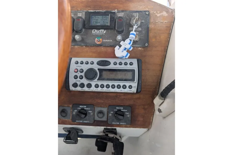 Slide: The Image of Control panel of a 2007 Duffy Cuddy Cabin 22 boat with radio and switches. - 29