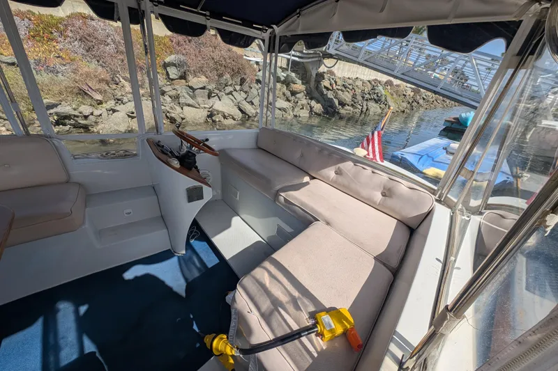 Slide: The Image of Interior of a 2007 Duffy Cuddy Cabin 22 boat with seating and steering wheel. - 7