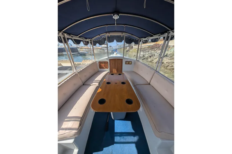 Slide: The Image of Interior of a 2007 Duffy Cuddy Cabin 22 boat with seating and table. - 9