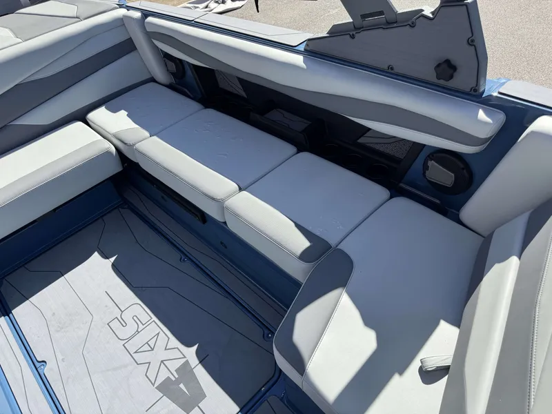 Slide: The Image of Interior of a 2026 Axis A225 boat with gray upholstered seats. - 12