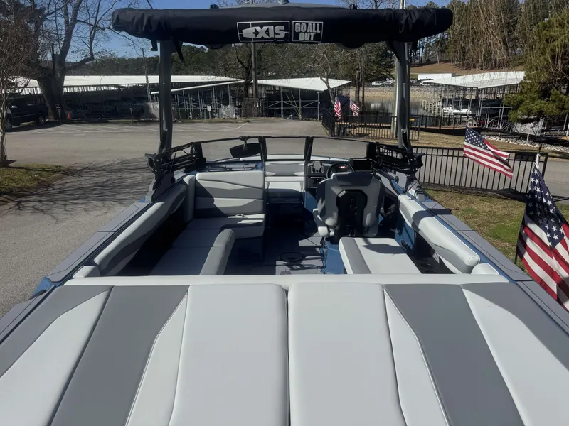 Slide: The Image of 2026 Axis A225 boat with gray seating and American flags. - 2