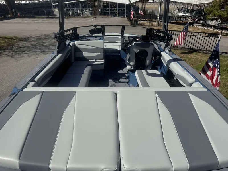 Slide: The Image of 2026 Axis A225 boat with gray upholstery and American flags. - 8