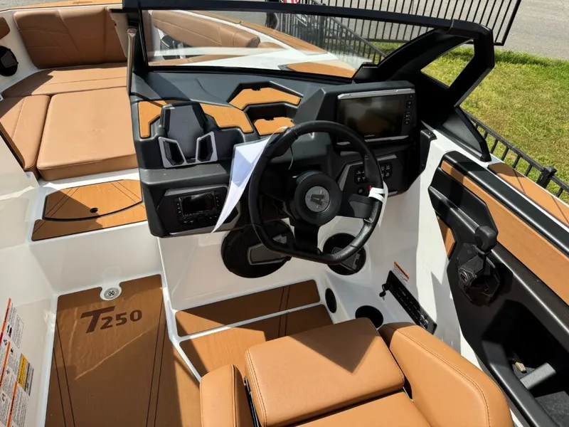 Slide: The Image of Interior of Axis T250 boat, 2026 model, featuring brown seats and steering wheel. - 13