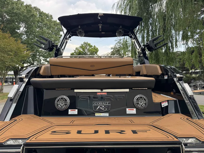 Slide: The Image of Rear view of 2026 Cobalt R6 Surf boat with brown seating. - 35