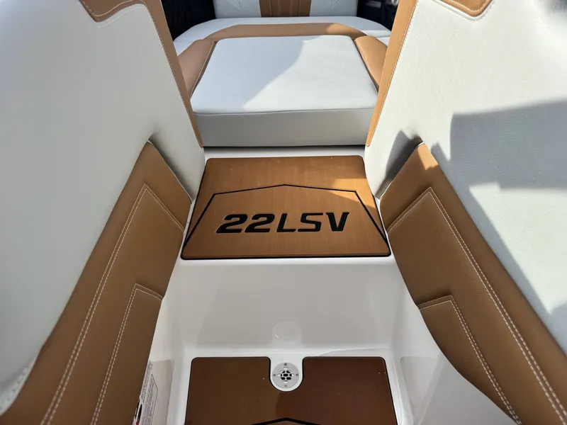 Slide: The Image of Interior of 2026 Malibu Wakesetter 22 LSV with brown and white seating. - 9