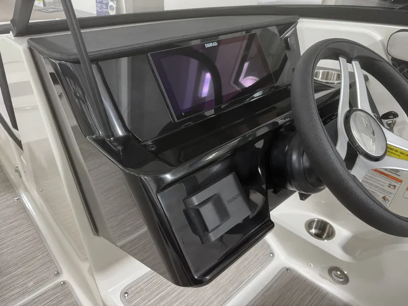 Slide: The Image of 2026 Sea Ray SPO210 boat console with steering wheel and display. - 13