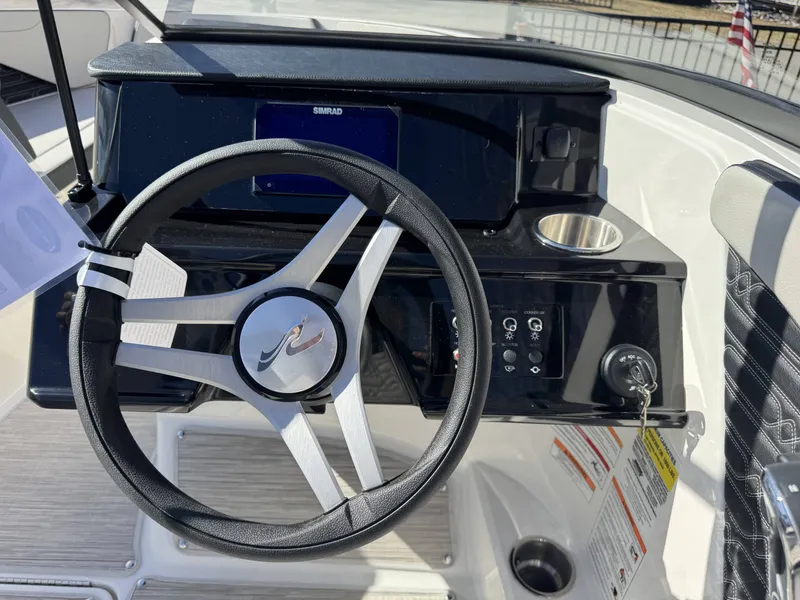 Slide: The Image of Steering wheel and dashboard of Sea Ray SPO210 boat, year 2026. - 12