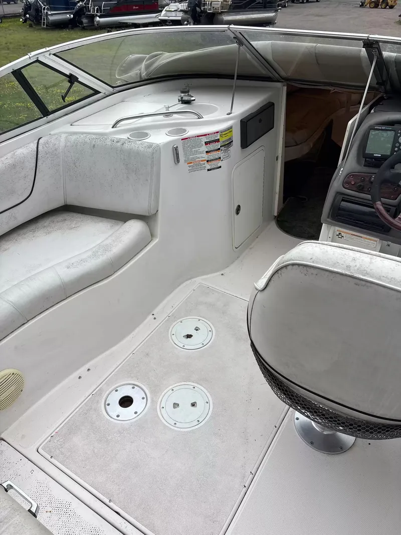 Slide: The Image of Interior of a 2000 Ebbtide MYST 2400FUN/DC boat with seating area and helm console. - 3