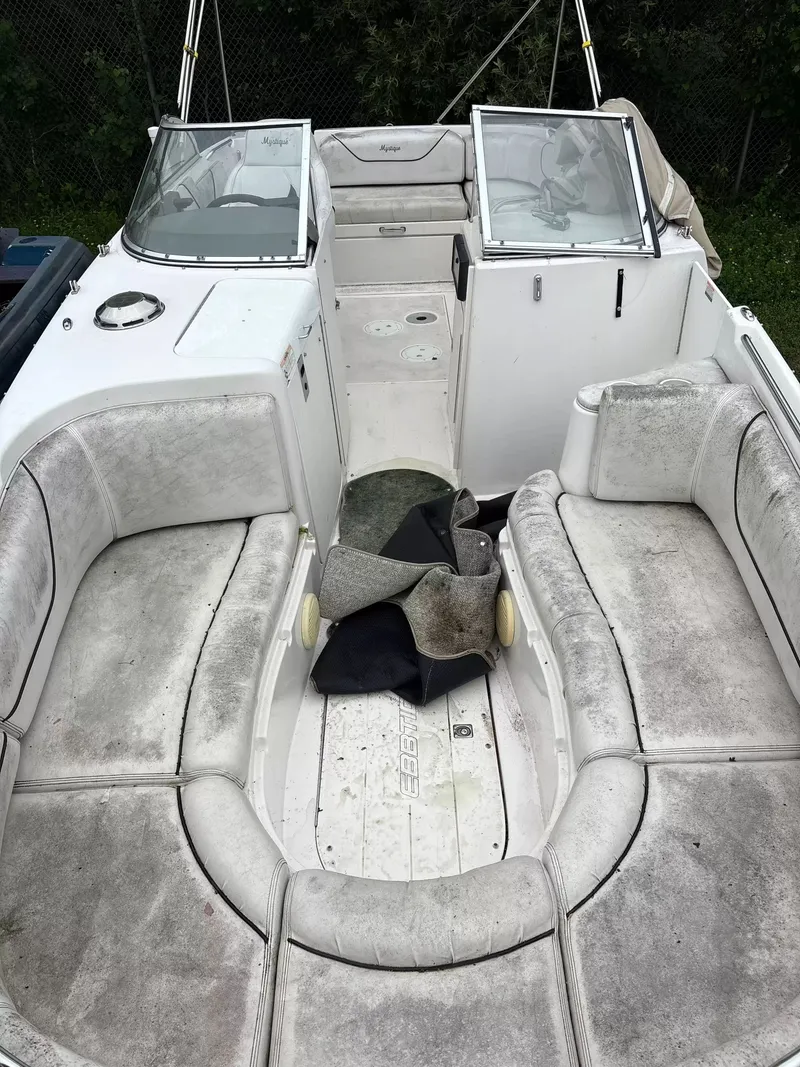 Slide: The Image of 2000 Ebbtide MYST 2400FUN/DC with spacious cockpit and worn upholstery. - 5