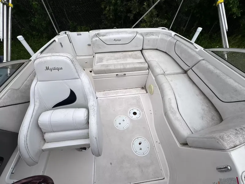 Slide: The Image of Interior of a 2000 Ebbtide MYST 2400FUN/DC boat with white upholstered seating. - 4