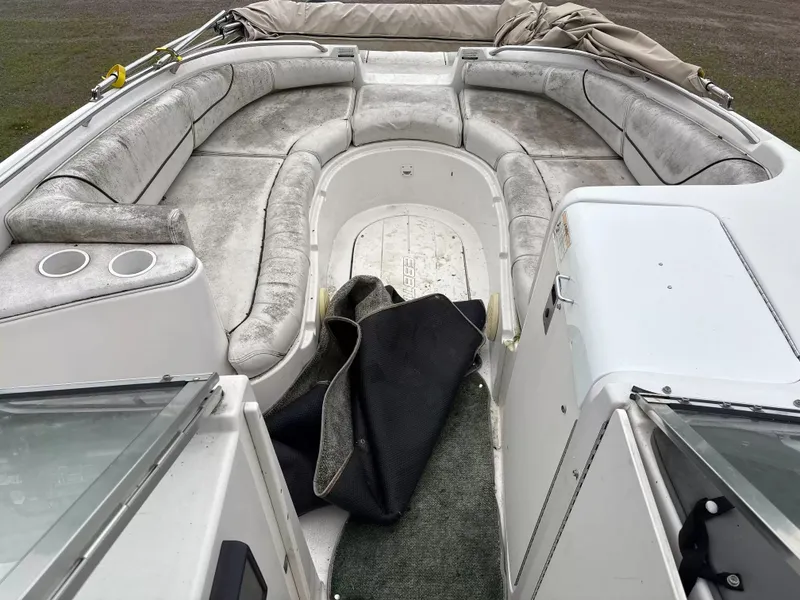 Slide: The Image of The image shows the cockpit of a 2000 Ebbtide MYST 2400FUN/DC boat with gray upholstery. - 6