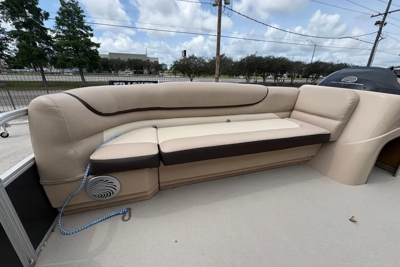 Slide: The Image of 2016 Sun Tracker Party Barge 20 DLX with beige seating and outdoor setting. - 12