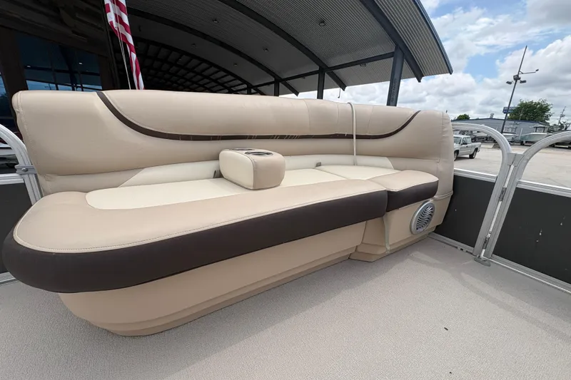 Slide: The Image of 2016 Sun Tracker Party Barge 20 DLX interior seating with beige and brown upholstery. - 13