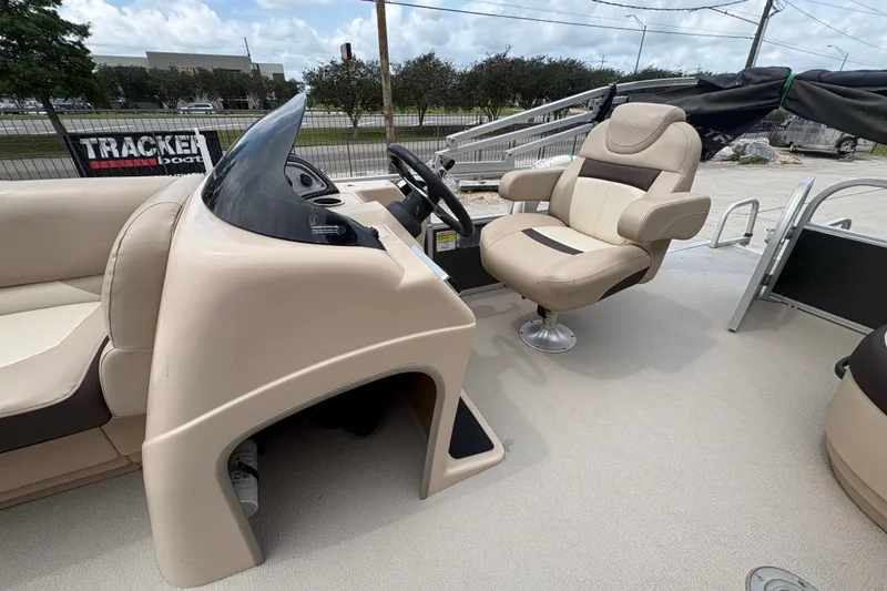 Slide: The Image of 2016 Sun Tracker Party Barge 20 DLX interior with captain's chair and console. - 15