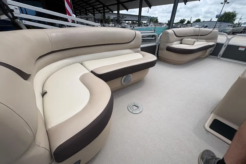 Slide: The Image of 2016 Sun Tracker Party Barge 20 DLX with beige seating and spacious deck. - 17