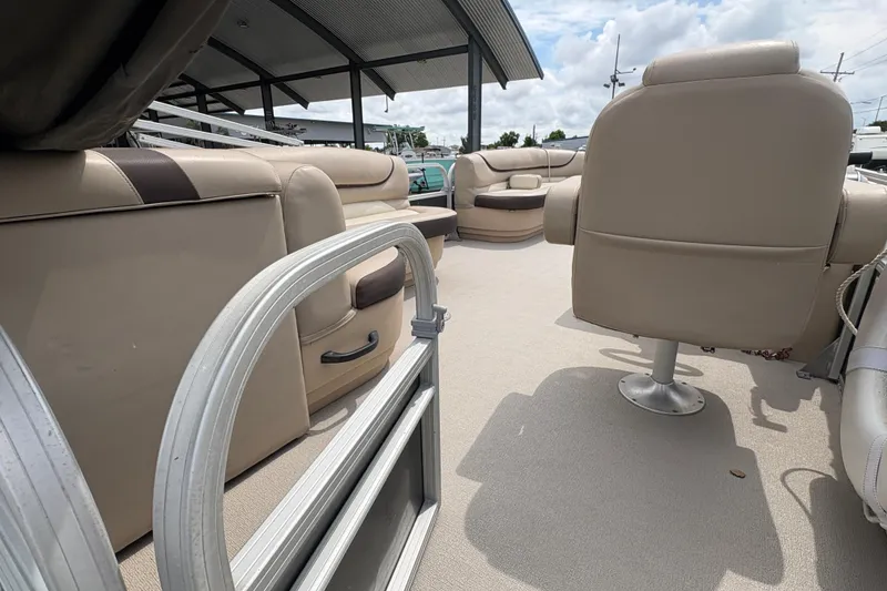 Slide: The Image of 2016 Sun Tracker Party Barge 20 DLX interior with beige seating and open deck. - 19