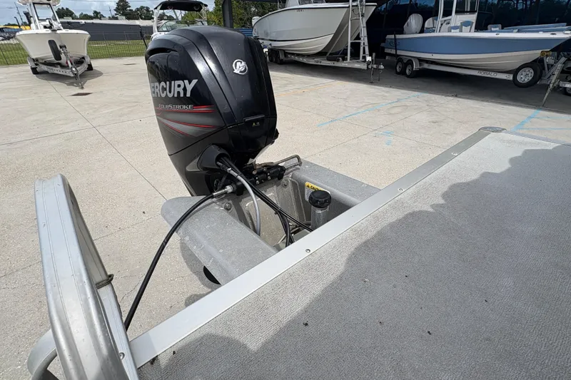 Slide: The Image of 2016 Sun Tracker Party Barge 20 DLX with Mercury FourStroke engine in a boatyard. - 20