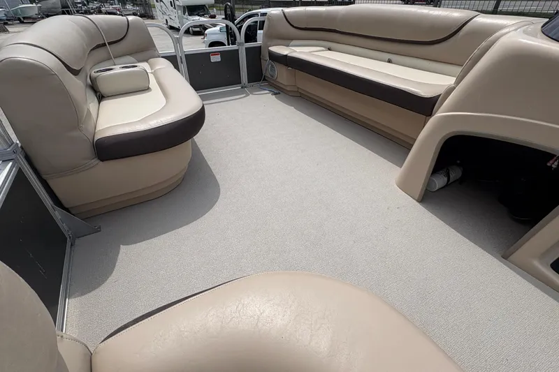Slide: The Image of Interior of a 2016 Sun Tracker Party Barge 20 DLX with beige seating. - 21