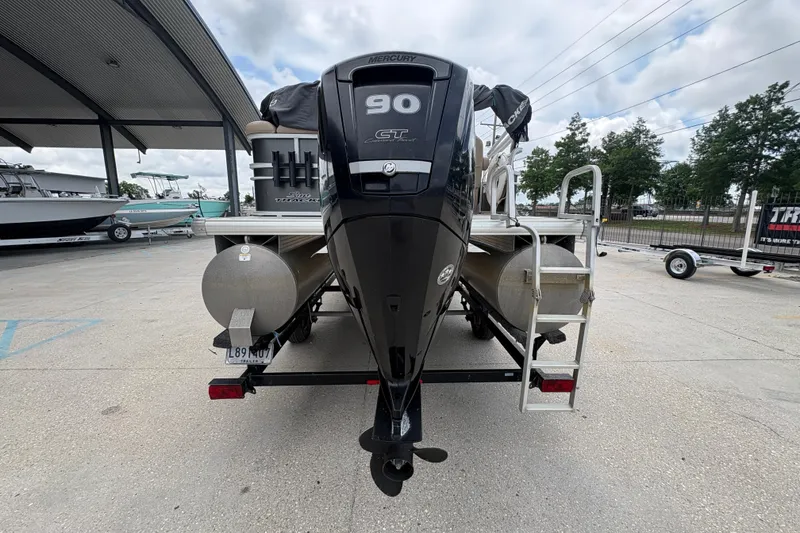 Slide: The Image of 2016 Sun Tracker Party Barge 20 DLX with Mercury 90 HP engine, parked outdoors. - 5