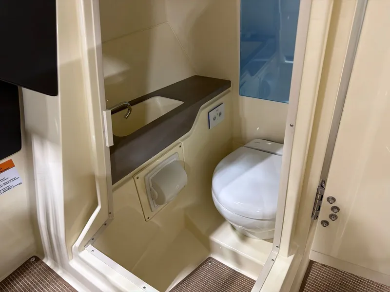 Slide: The Image of Interior of 2026 Chris-Craft Sportster 28 with toilet and sink. - 16