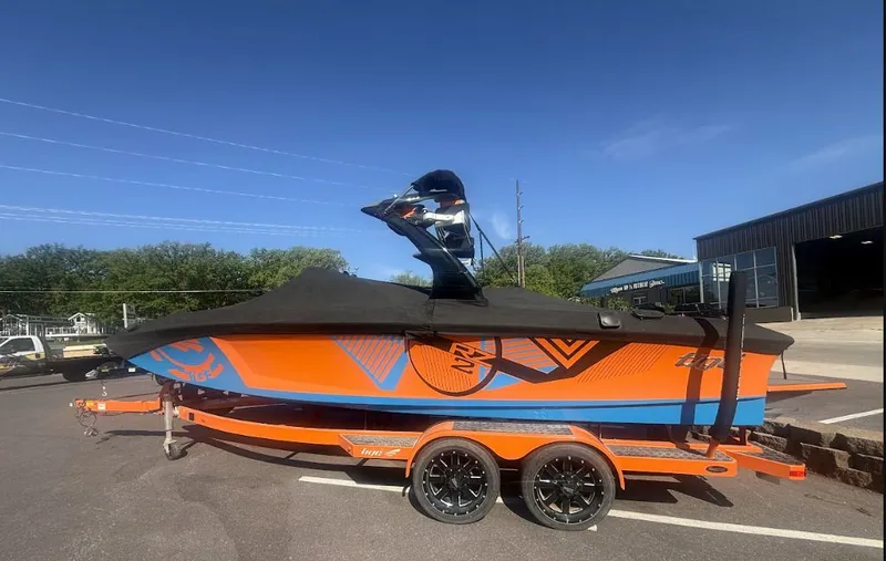 The Image of 2016 Tigé RZ2 boat on trailer, orange and blue, side view. - 0