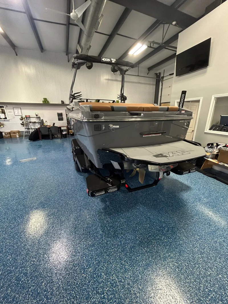 Slide: The Image of 2026 Axis T235 boat in showroom with blue flooring. - 3
