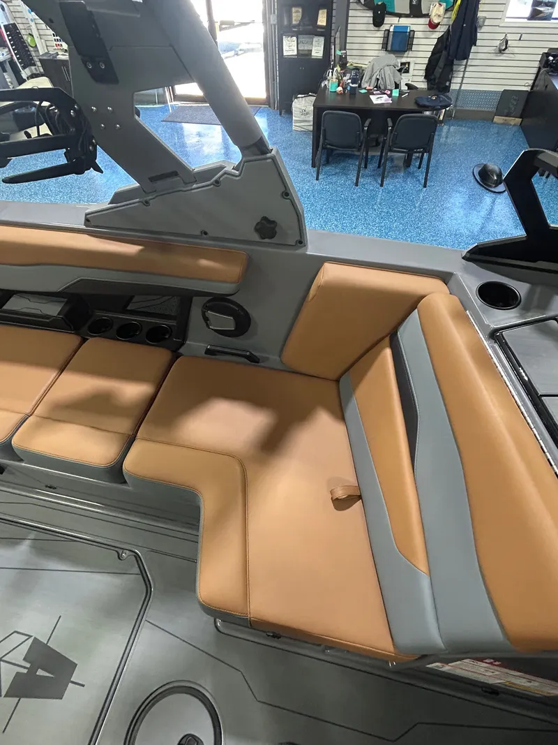 Slide: The Image of Interior of Axis T235 boat, 2026 model, featuring beige seating. - 9