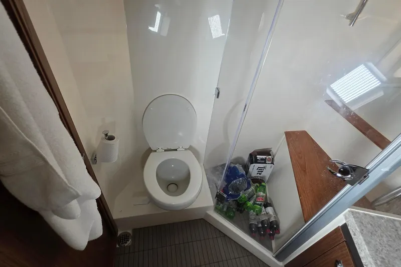 Slide: The Image of Bathroom in 2018 Sea Ray Sundancer 510 yacht with toilet and shower area. - 12