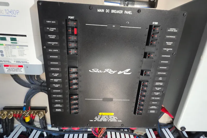 Slide: The Image of Main DC breaker panel of 2018 Sea Ray Sundancer 510 yacht, featuring labeled switches and wiring. - 18
