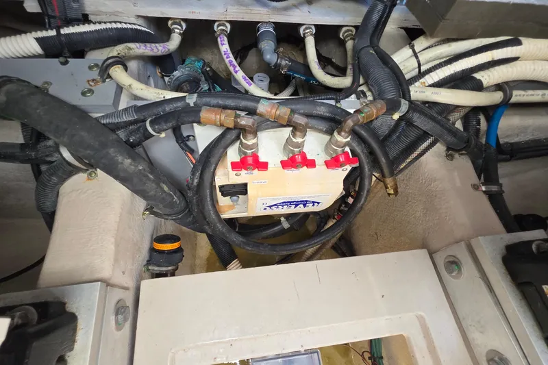 Slide: The Image of Engine compartment of 2018 Sea Ray Sundancer 510 with visible hoses and valves. - 23