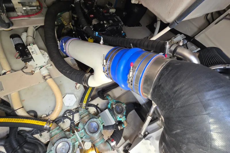 Slide: The Image of Engine room of 2018 Sea Ray Sundancer 510, showcasing complex piping and components. - 24