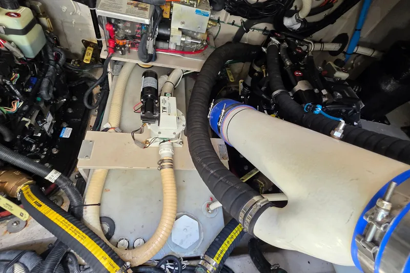 Slide: The Image of Engine room of a 2018 Sea Ray Sundancer 510 with complex piping and machinery. - 30