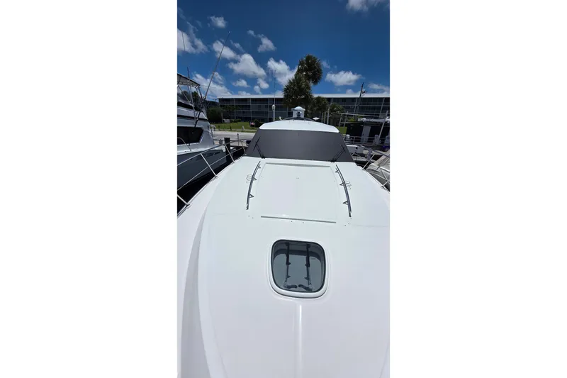 Slide: The Image of 2018 Sea Ray Sundancer 510 yacht docked under a clear blue sky. - 33