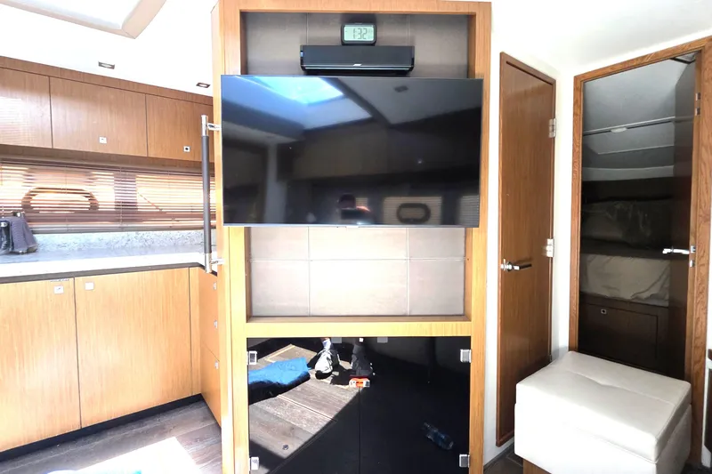 Slide: The Image of Interior of 2018 Sea Ray Sundancer 510 yacht with TV and modern wood cabinetry. - 39