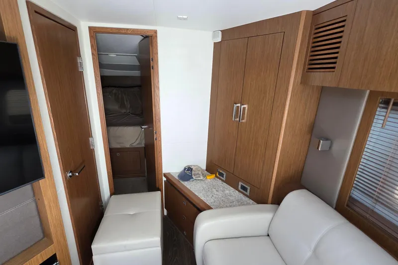 Slide: The Image of Interior of 2018 Sea Ray Sundancer 510 yacht with modern wood cabinetry and seating. - 40