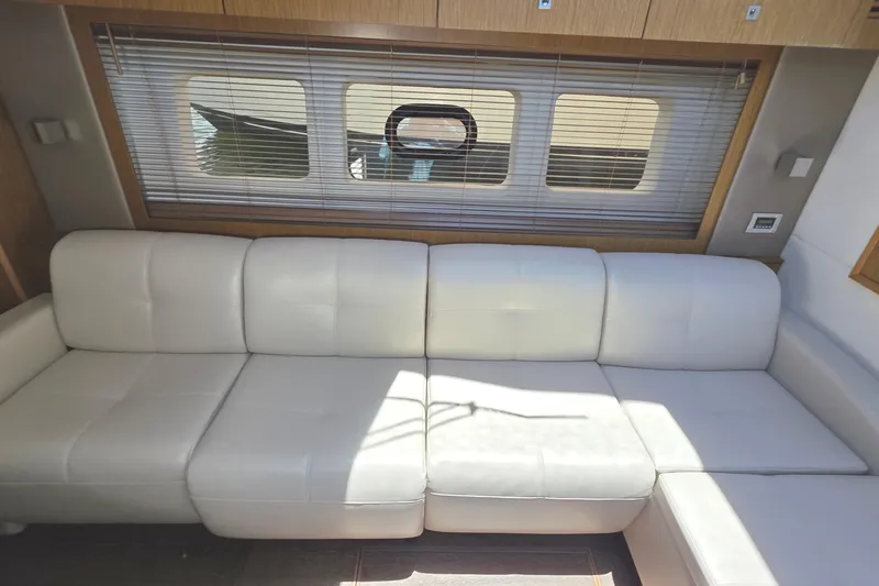 Slide: The Image of Luxurious white leather seating inside 2018 Sea Ray Sundancer 510 yacht cabin. - 41