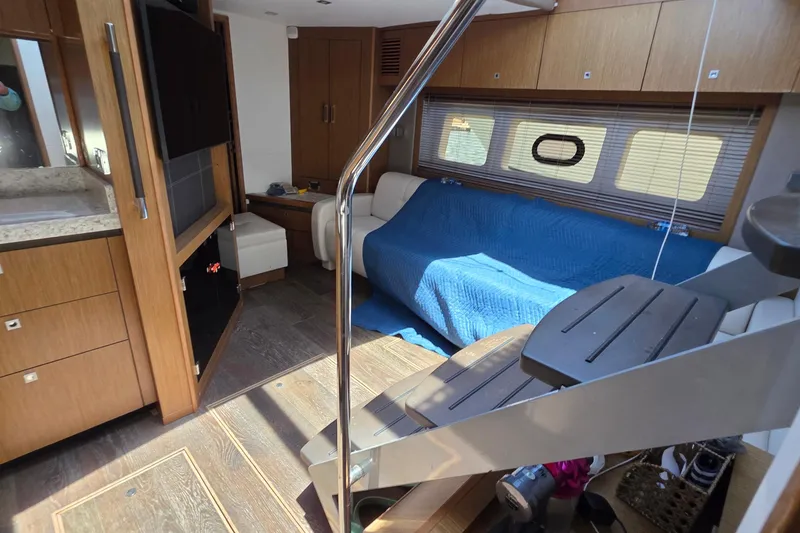 Slide: The Image of Interior of 2018 Sea Ray Sundancer 510 yacht, featuring modern wood cabinetry and cozy seating. - 44